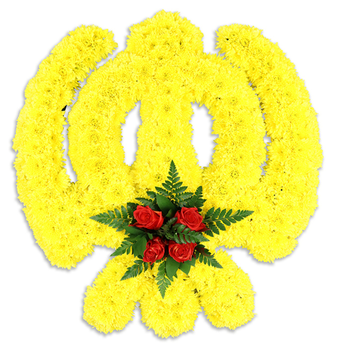 Against a pure white field, an exquisitely detailed Khanda emblem has been rendered in flowers with reverent care: thousands of tight, bright yellow chrysanthemum blooms form the rounded chakkar, the winged curves of the two kirpans, and the upright double-edged sword at the centre, giving the symbol a warm, tactile presence and a subtly sculpted profile. The yellow florets, packed densely, create a soft, almost quilted texture that plays with light and shadow across the emblem's curves and points. Nestled where the elements converge is a focused cluster of deep red roses-five to six buds, their petals richly layered-surrounded by lush dark green fern fronds that provide a crisp, botanical frame and lift the red as a solemn focal heart. The studio-style lighting makes the colours sing: a sunny, saturated yellow balanced by velvety crimson and cool green, while a modest shadow beneath confirms this as a substantial three-dimensional tribute, likely intended as a funeral wreath or ceremonial centrepiece. The scent is understated: green chrysanthemum freshness with a soft rose perfume, lending comfort rather than theatrics. This arrangement reads as both an artistic statement and a respectful offering for Sikh religious occasions, memorials, and cultural gatherings, designed with the proportional fidelity that faith communities expect. Local families across Eastcote, and neighbouring communities in Ruislip and Pinner, will recognise the formal vocabulary of colour and form-choices made to honour tradition while keeping craftsmanship and dignity foremost in mind.