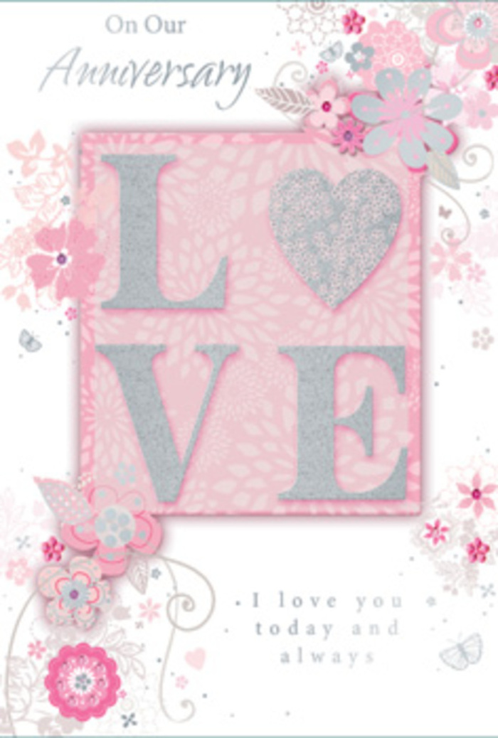 This anniversary card evokes the feeling of walking into a light-filled Eastcote home where flowers and memories hold pride of place. The design is centred on the word LOVE, printed in generous, raised capitals that form a strong, clean focal point. Each letter is adorned with a dusting of soft, silver-toned glitter, the particles so fine they resemble a frosted sheen rather than coarse sparkle. When you imagine running your fingertips over them, they would feel gently textured, like the delicate grain of luxury card stock paired with a subtle, glittering overlay. Surrounding the central word, an arrangement of illustrated blooms and swirling foliage stretches towards the edges of the card. The flowers are drawn with a florist's eye for balance-small, stylised blossoms in blush pink and creamy white, accented by hints of grey and silver that suggest cool-toned foliage and metallic ribbon. Their placement is fluid, not rigid, as though someone has sketched a bouquet mid-flow, capturing the natural drape of stems and leaves. Curving vines and tendrils sweep around the word LOVE, almost cradling it, while tiny dots and flourishes lend a hint of whimsical movement, reminiscent of petals fluttering in a gentle Eastcote breeze. The background remains a consistent, dreamy pink, giving the entire scene a soft focus, like a cherished photograph. A heartfelt anniversary message appears in elegant, flowing script, its letters slim and elongated, mirroring the curves of the surrounding stems. Together, these elements create a sense of tenderness, artistry, and enduring devotion-much like an anniversary arrangement personally chosen from a local Eastcote florist and delivered to celebrate yet another meaningful year together.